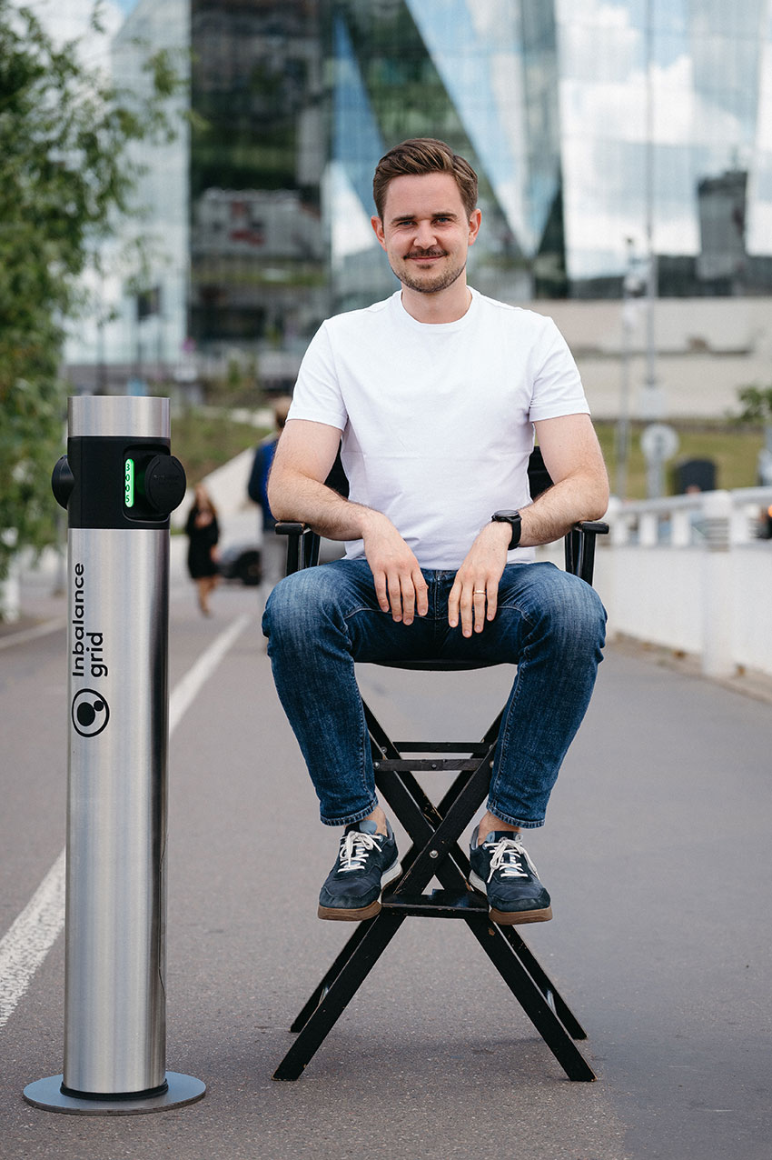 Inbalance grid CEO Simonas Stankus with a charger same as will be installed in Poland